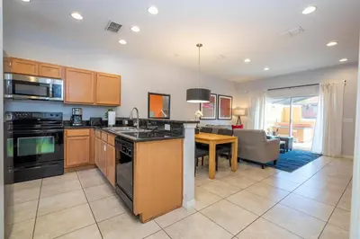 a kitchen and living room with a dining room at Beautiful 2 bedrooms with Hot tube in Kissimmee
