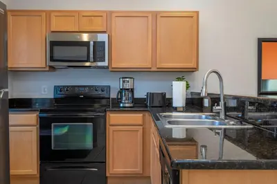 a kitchen with a sink and a microwave at Beautiful 2 bedrooms with Hot tube in Kissimmee