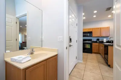 a bathroom with a sink and a counter with a mirror at Cozy 2 bedrooms with Hot tube in Kissimmee