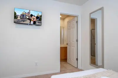 a room with a tv hanging on the wall at Cozy 2 bedrooms with Hot tube in Kissimmee