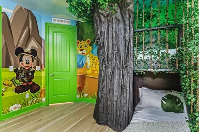 a bedroom with a mickey mouse bedroom with a tree and a bed at Magical Memories Villa 10bd Near Disney in Orlando