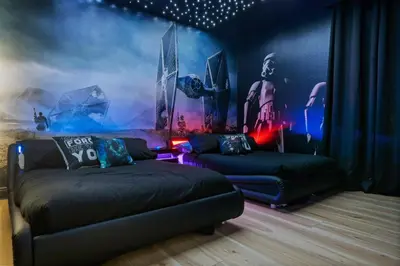 a bedroom with a bed and a couch and a painting at Magical Memories Villa 10bd Near Disney in Orlando