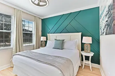 a bedroom with a bed and a green wall at Magical Memories Villa 10bd Near Disney in Orlando