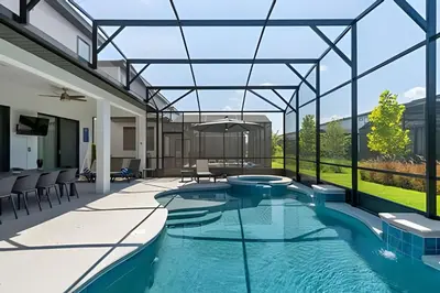 a swimming pool in a house with glass walls at Mansão 9Q Paradiso Grande. Piscina, Sala de Jogos in Orlando