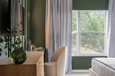 a bedroom with a window and a desk and a chair at 10min to Disney, Luxury 6BR Themed Villa with Private Pool,Spa and Game Room in Orlando