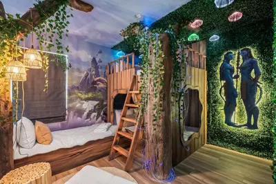 a room with a green ivy covered wall at 10min to Disney, Luxury 6BR Themed Villa with Private Pool,Spa and Game Room in Orlando