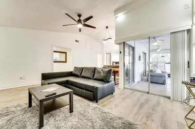 a living room with a couch and a ceiling fan at 3 Mi to SeaWorld! Suburban Home with Screened Porch in Orlando
