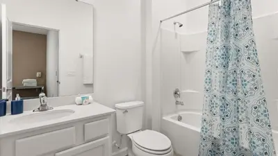 a bathroom with a toilet and a shower curtain at Upstay Veranda Palms Villa Pool Hot Tub & Games in Kissimmee