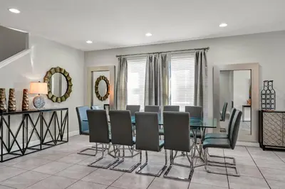 a dining room with a table and chairs at Fun-Filled Getaway With Private Pool, Theme Rooms & Game Room And Waterpark Access Near Disney At Encore Resorts Reunion - 7604Mc in Orlando
