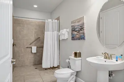 a white bathroom with a toilet and a sink at Fun-Filled Getaway With Private Pool, Theme Rooms & Game Room And Waterpark Access Near Disney At Encore Resorts Reunion - 7604Mc in Orlando
