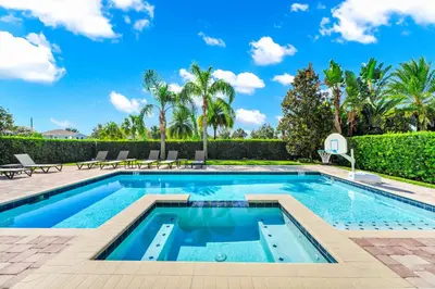 a swimming pool in a villa with palm trees at Fun-Filled Getaway With Private Pool, Theme Rooms & Game Room And Waterpark Access Near Disney At Encore Resorts Reunion - 7604Mc in Orlando