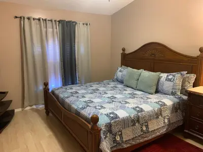 a bedroom with a bed with a quilt on it at Ortona's Best Kept Secret Three-Two Spacious Home in Orlando