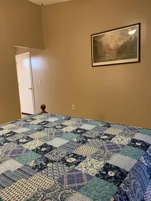 a quilt on a bed in a bedroom at Ortona's Best Kept Secret Three-Two Spacious Home in Orlando