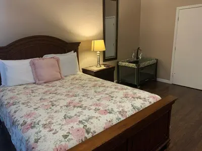 a bedroom with a bed with a floral comforter at Ortona's Best Kept Secret Three-Two Spacious Home in Orlando