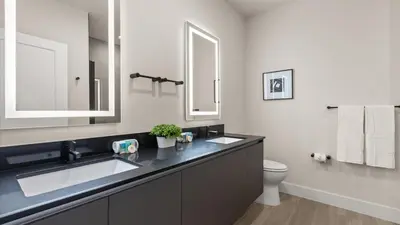 a bathroom with two sinks and a toilet at Stunning Townhome with Private Pool & Games Room in Orlando