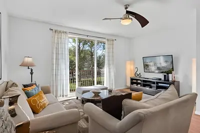 a living room with white furniture and a large window at Casa 3Q Vista Cay – Perto da Universal & Centro in Orlando