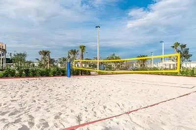 a volleyball court with a yellow volleyball net on a beach at Villa Sanches 4Q c/ Piscina – Storey Lake Resort in Kissimmee