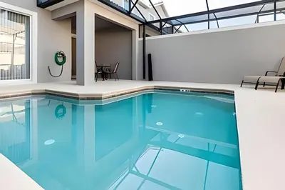 a swimming pool with blue water in a building at Villa Sanches 4Q c/ Piscina – Storey Lake Resort in Kissimmee