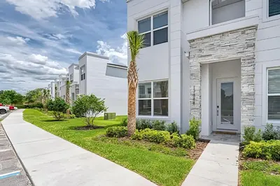 a palm tree in front of a white building at Casa 4Q Hidden Forest c/ Piscina in Orlando