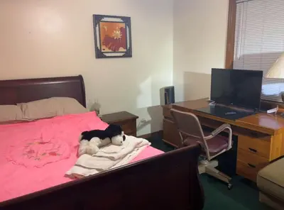 a bedroom with a teddy bear laying on a bed at Red brick house in Kissimmee