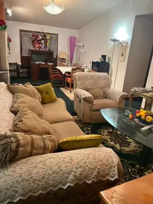 a living room with couches and a table at Red brick house in Kissimmee