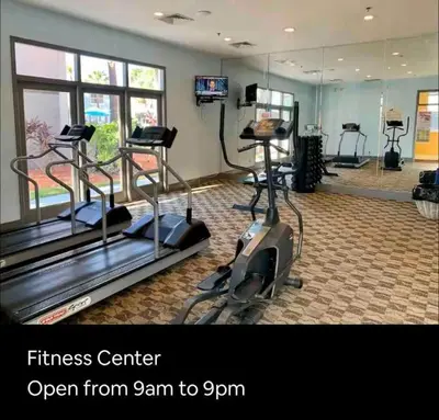 a fitness center with treadmills and a gym at Mickey's Hideaway Condo Near Disney in Orlando