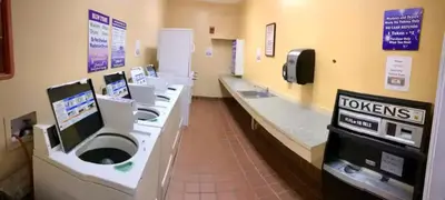 a bathroom with a row of sinks and toilets at Mickey's Hideaway Condo Near Disney in Orlando