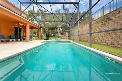 an empty swimming pool in a house at Family Retreat near Disney with Private Pool in Kissimmee