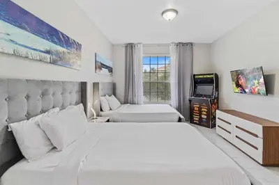 a bedroom with two beds and a tv in it at Apartamento 3 Quartos Amplo no Vista Cay Resort in Orlando