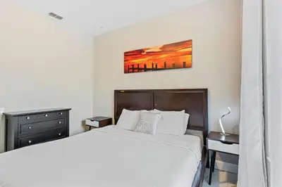 a bedroom with a bed and a painting on the wall at Apartamento 3 Quartos Amplo no Vista Cay Resort in Orlando