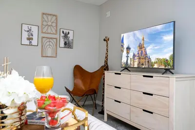 a living room with a tv on a dresser at Enchanting 6BR, Themed Rooms, Game Room and Resort in Kissimmee