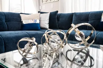 two metal sculptures on a glass table in front of a couch at Enchanting 6BR, Themed Rooms, Game Room and Resort in Kissimmee
