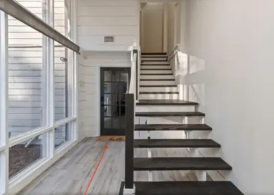 a staircase in a tiny house with windows at Kissimmee Retreat with Jacuzzi and Games in Kissimmee