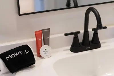 a bathroom counter with a sink with a faucet at Kissimmee Retreat with Jacuzzi and Games in Kissimmee