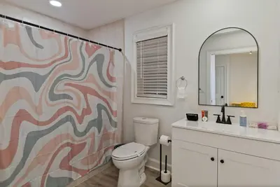 a bathroom with a toilet and a shower curtain at Kissimmee Retreat with Jacuzzi and Games in Kissimmee