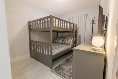 a childs bedroom with a bunk bed and a lamp at Family-Friendly Apartment Near Disney & Universal in Kissimmee