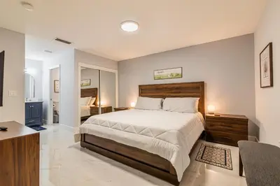 a bedroom with a large bed and a desk at Family-Friendly Apartment Near Disney & Universal in Kissimmee