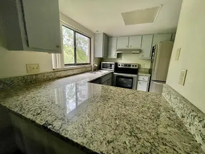 a kitchen with a granite counter top in a room at Residence near trails, shopping in Orlando