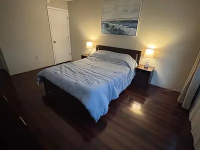a bedroom with a bed and two lamps on two tables at Residence near trails, shopping in Orlando