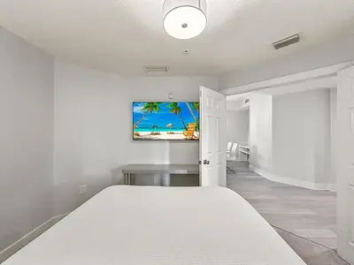 a bedroom with a bed and a tv on the wall at Family-Friendly 3-Bedroom Condo for 6 and 5 min to Disney in Orlando