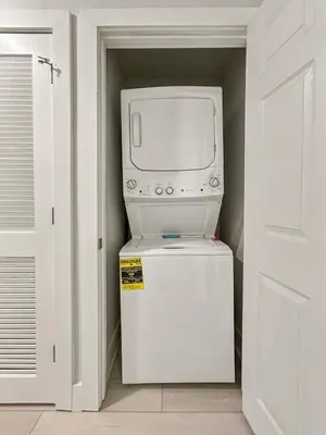 a microwave oven sitting on top of a refrigerator at Family-Friendly 3-Bedroom Condo for 6 and 5 min to Disney in Orlando