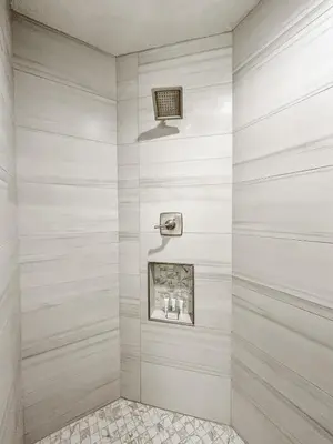 a walk in shower with white walls at Family-Friendly 3-Bedroom Condo for 6 and 5 min to Disney in Orlando