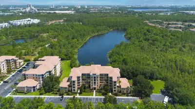 an aerial view of an apartment complex with a lake at Family-Friendly 3-Bedroom Condo for 6 and 5 min to Disney in Orlando