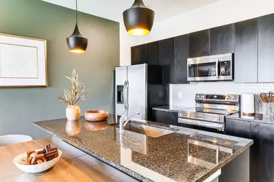 a kitchen with stainless steel appliances and a counter top at 4 Mi to Disney! Pet-Friendly Home with Pool Access in Kissimmee