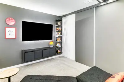 a living room with a flat screen tv on a wall at 4 Mi to Disney! Pet-Friendly Home with Pool Access in Kissimmee