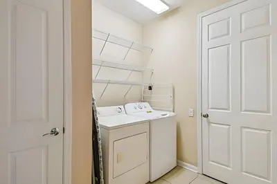 a white laundry room with a washer and dryer at Apartamento Vista Cay: ao lado do UNIVERSAL in Orlando