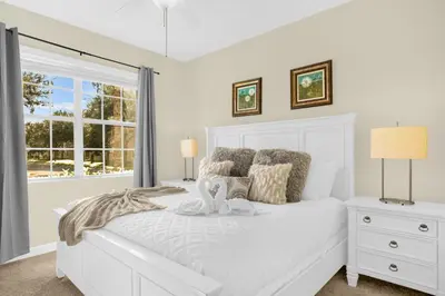 a white bedroom with a white bed and a window at Fun Family Villa Pool BBQ Near Disney World in Kissimmee