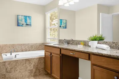 a bathroom with a sink and a bath tub at Fun Family Villa Pool BBQ Near Disney World in Kissimmee