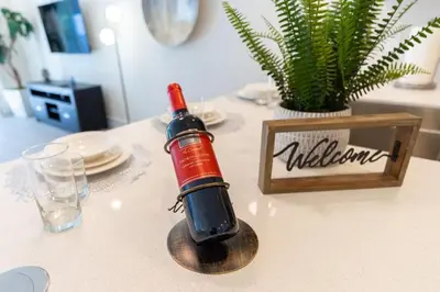 a bottle of wine sitting on top of a table at Disney Escape 3BR Home Pool in Orlando