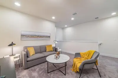 a living room with a couch and a table at Disney Escape 3BR Home Pool in Orlando